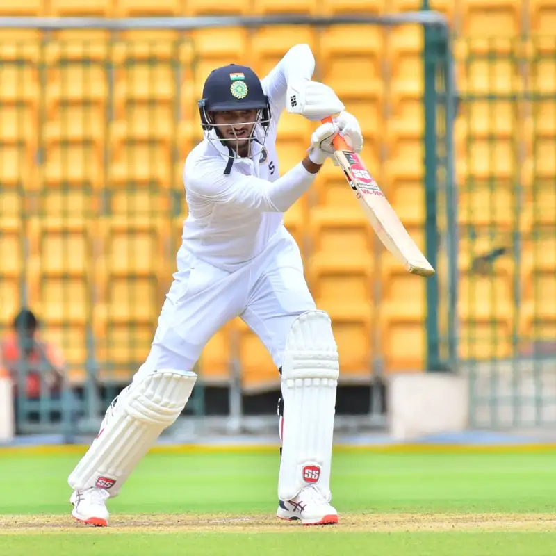 a man in white playing cricket